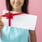 smiley woman showing envelope