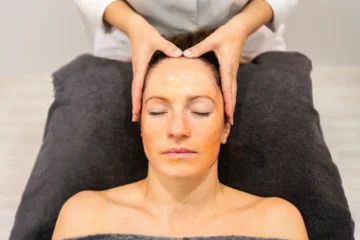 crop cosmetologist massaging female client on face 2024 02 06 19 10 47 utc